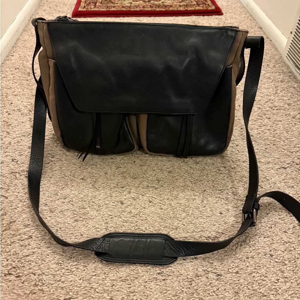 Kooba black leather and tan canvas shoulder bag.